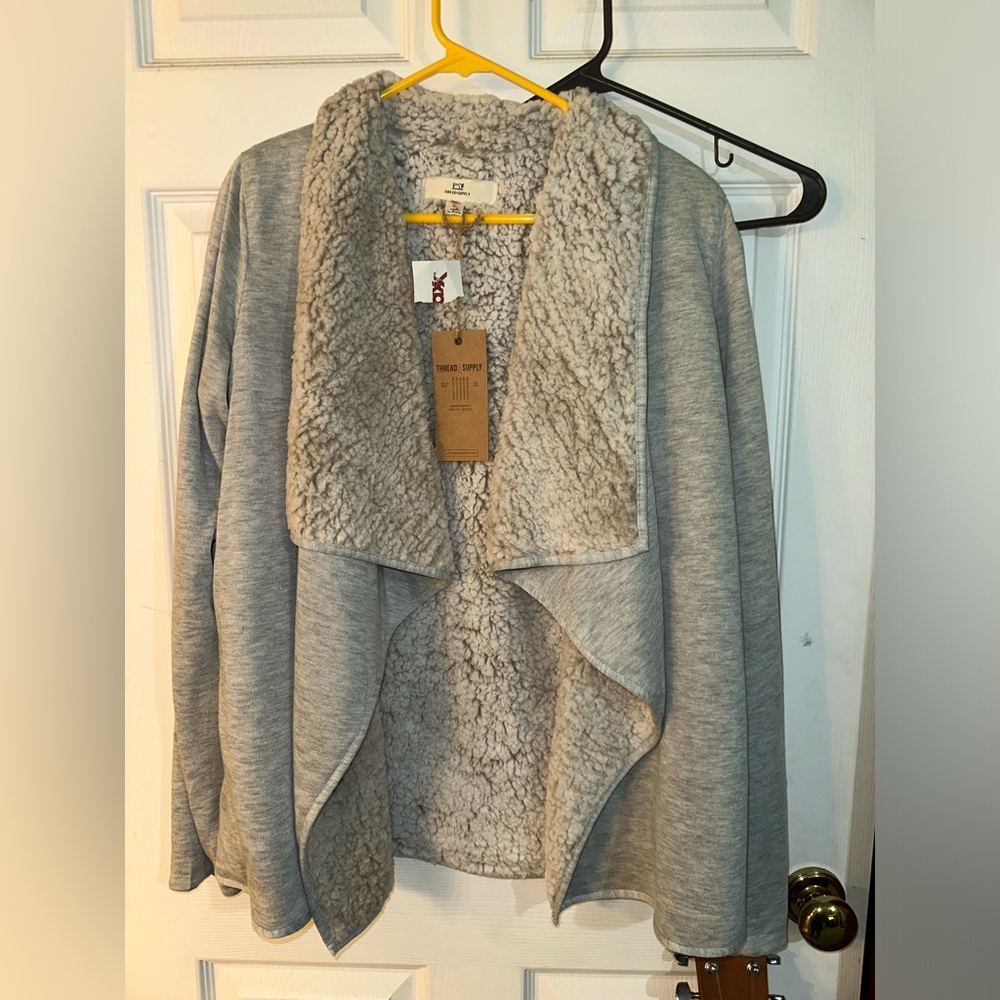 Light gray colored open cardigan.